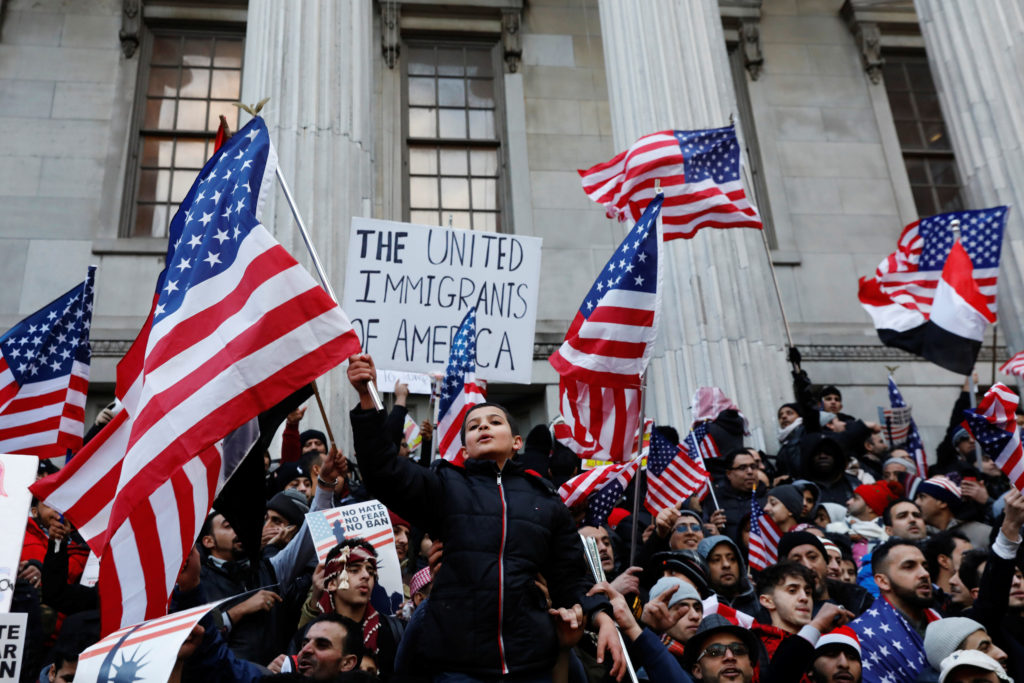 Arab American demonstrators holding American Flags protesting against President Trump’s travel ban in Brooklyn, New York, February 2, 2017.