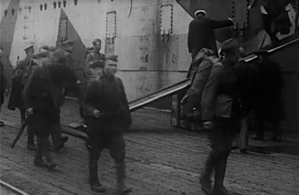 Thumbnail, black and white, people walking in a shipyard