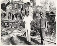 Men Standing Outside Destroyed House